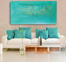 Living room with turquoise abstract painting, white sofa, and decorative elements.