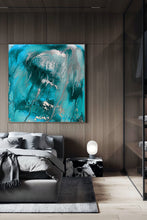 An abstract canvas painting with vibrant teal, turquoise, and silver paint strokes, displayed on a dark wood-paneled wall in a modern bedroom setting.