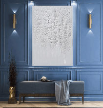 Decorative wall art piece on a blue paneled wall with a bench and decorative elements.