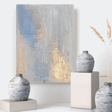 Decorative setting with abstract painting and textured vases on a white surface