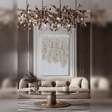 Modern living room with a white gold artwork, chandelier, sofa, and decorative items.