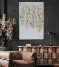 Modern interior with white abstract art, brown sofa, and decorative items.