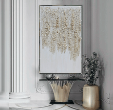 Decorative interior with large white gold abstract art, console table, and vase.