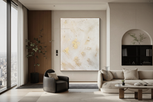 Modern living room with a large white gold abstract painting on the wall, by artist Julia Apostolova.