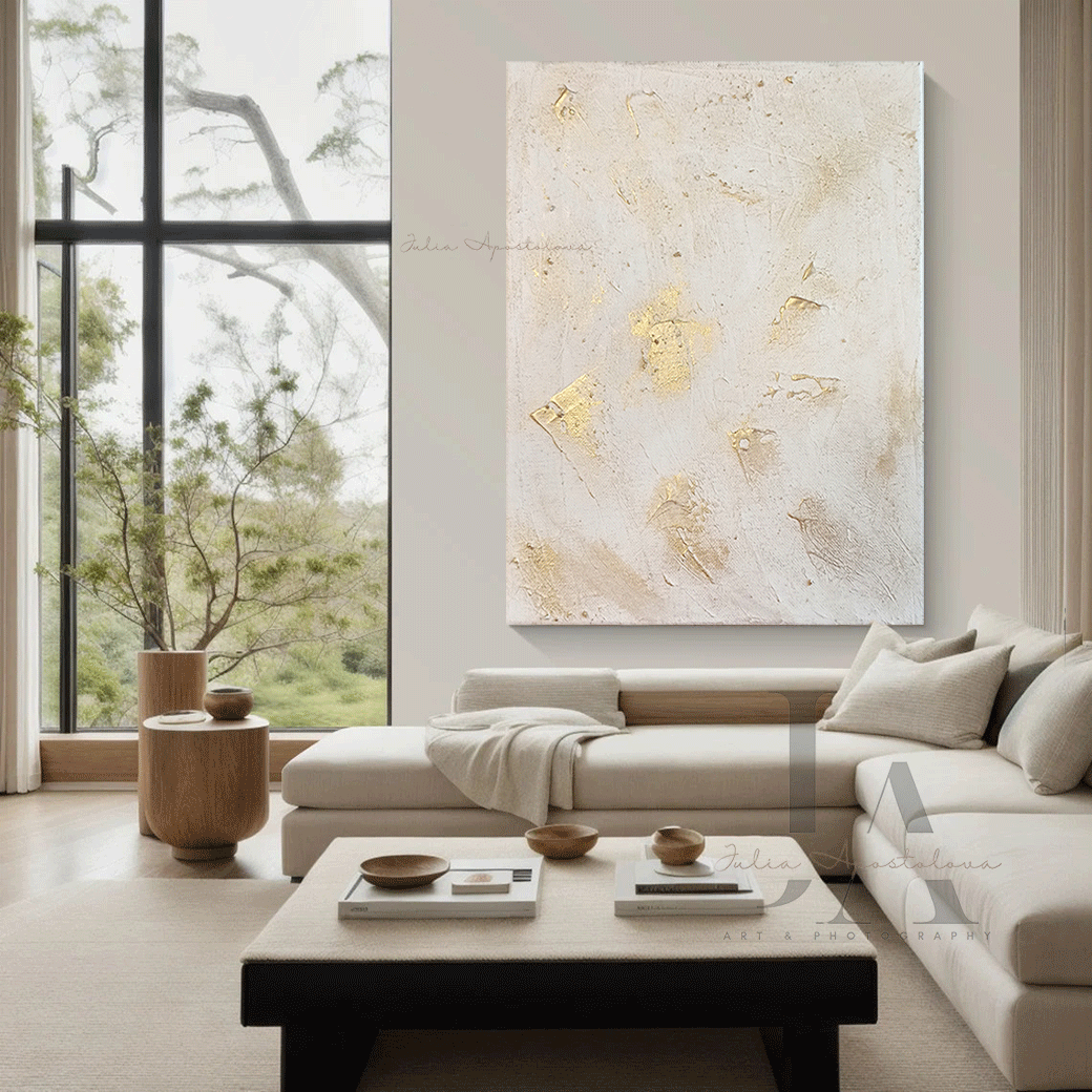 Modern living room with a large white gold abstract painting on the wall, a sectional sofa, and a coffee table.