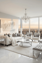 Modern living room with white silver glitter painting, white furniture, chandelier, and cityscape view.