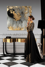 Woman in a black and gold dress standing in a stylish room with a large gold leaf abstract painting, painted by artist Julia Apostolova.