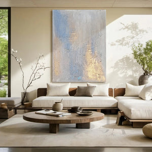 Modern living room with a sectional sofa, round wooden coffee table, and abstract painting on the wall.