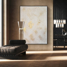 Modern interior with white gold abstract art, chaise lounge, and stylish lighting fixture.