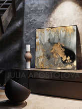 A contemporary abstract gold leaf canvas art featuring gray, black and metallic accents.